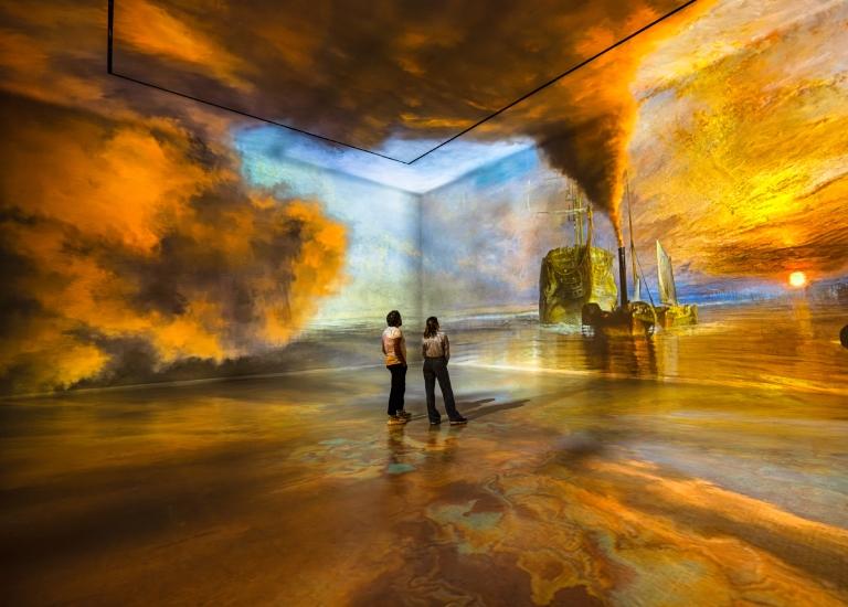 models standing in the world around us gallery at the frameless immersive art experience