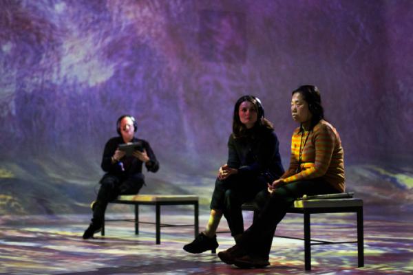 Three people siting in the immersive gallery at FRAMELESS