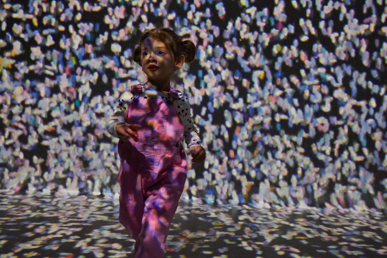 A child running in FRAMELESS immersive art experience.