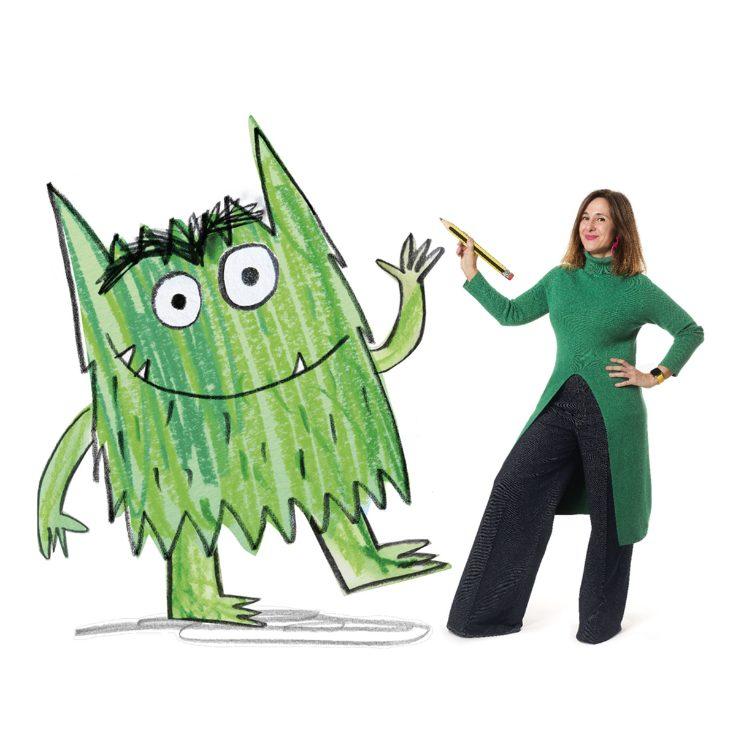 Author Anna Llenas poses with a life-size drawing of The Colour Monster.