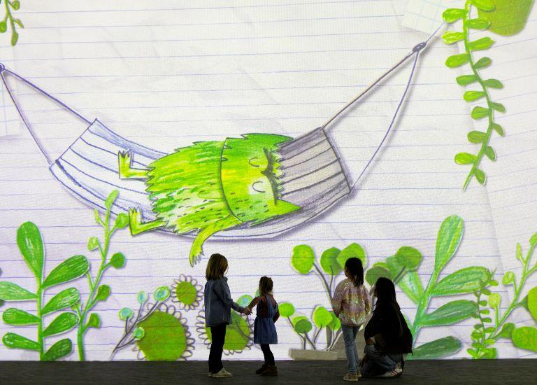 Three children stand with an adult at The Colour Monster at FRAMELESS Immersive Art Experience.