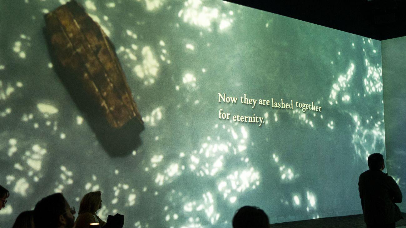 A projected screen showing a coffin with words on the screen.
